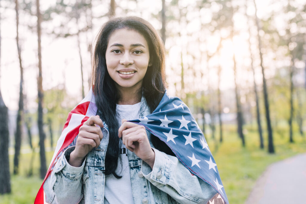 Solo Female Travel:
young-ethnic-woman-wrapped-american-flag
