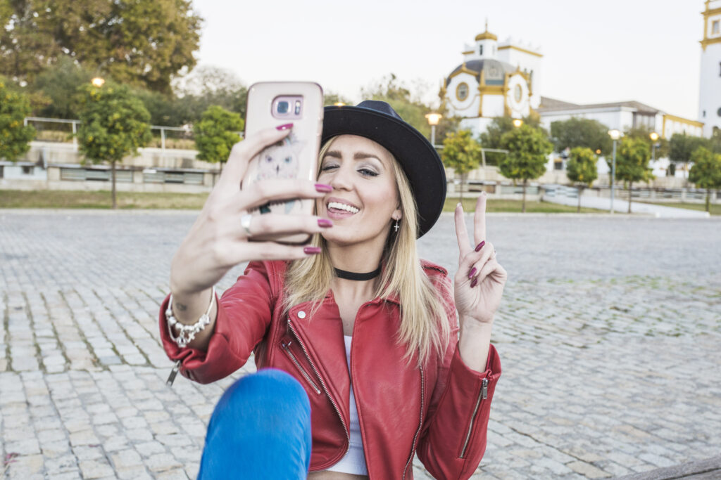 safe travels in Italian:
cheerful-woman-taking-selfie-street