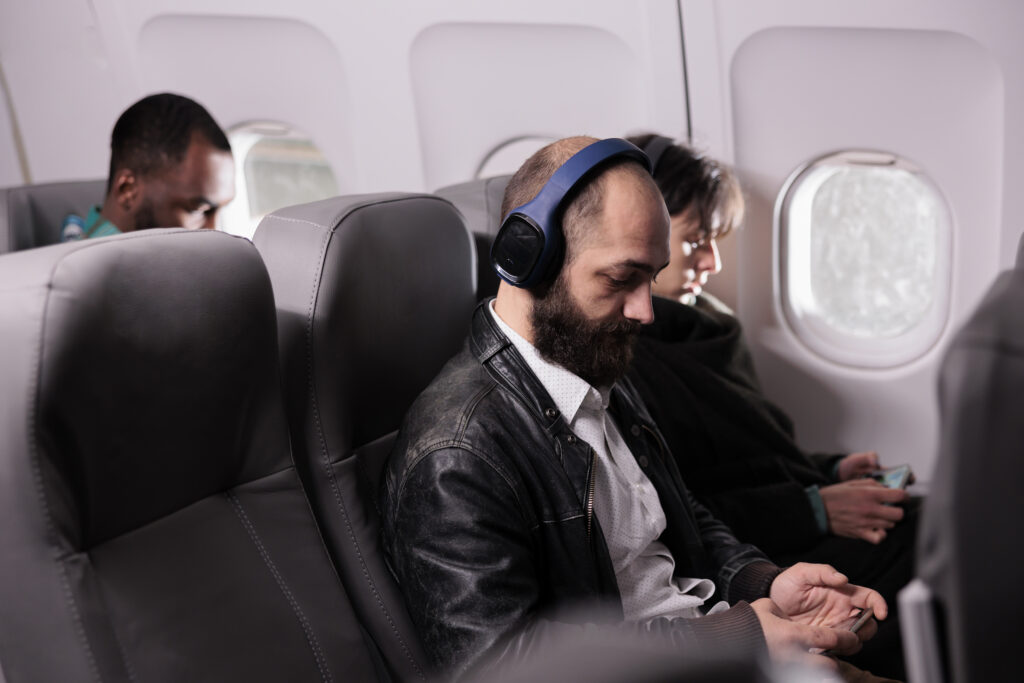 flights from Philadelphia to Atlanta: Diverse group of passengers travelling by airplane on commercial flight, flying with international airline to go on holiday trip. Travellers sitting in plane seats during aerial transportation.